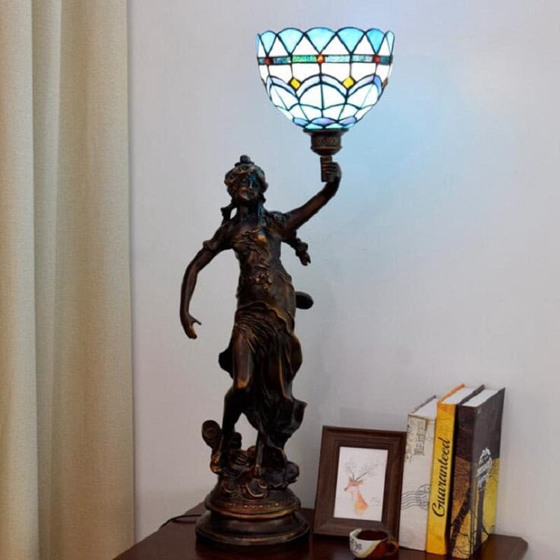 Tiffany style table lamp featuring a Statue design, combining artistic sculpture and elegant glasswork.